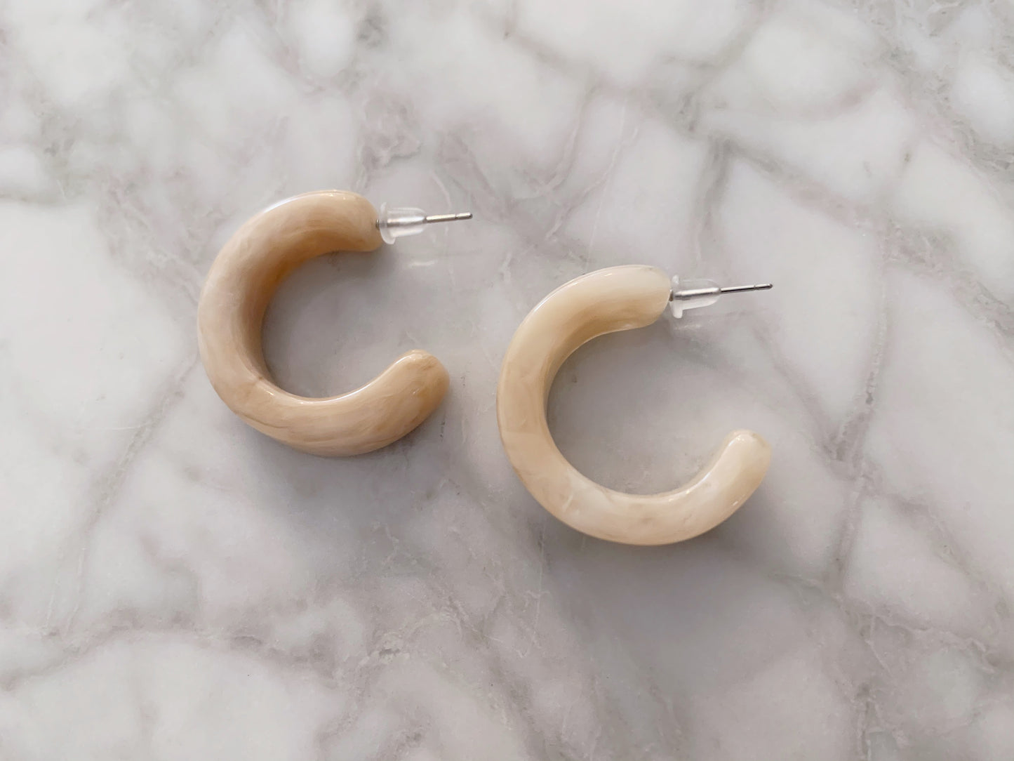 Marble stone half hoop pierces.